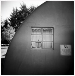 Window of outer building with a crucifix at YAM.jpg